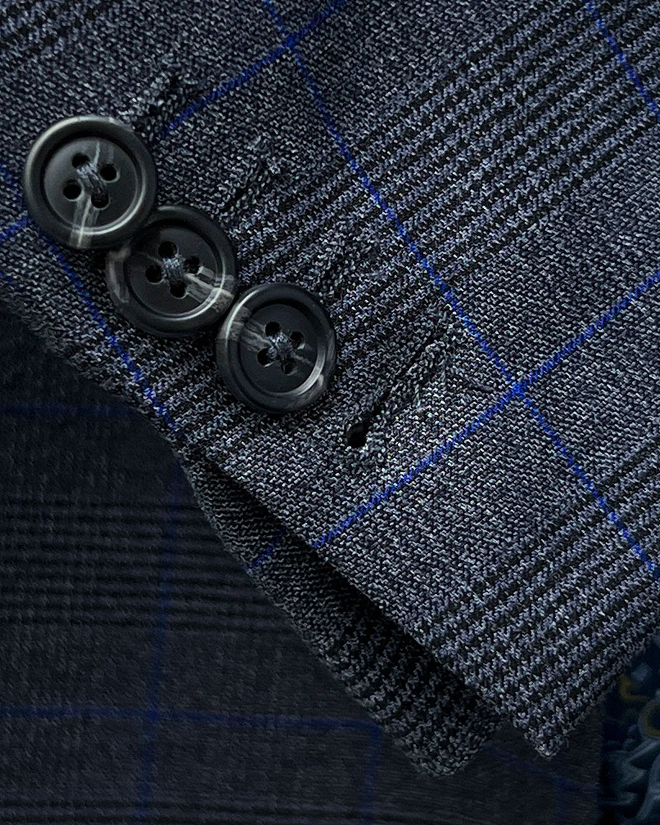 Detail shot of the working buttonholes on the suit sleeve cuff, a hallmark of custom tailored suits that demonstrates authentic craftsmanship