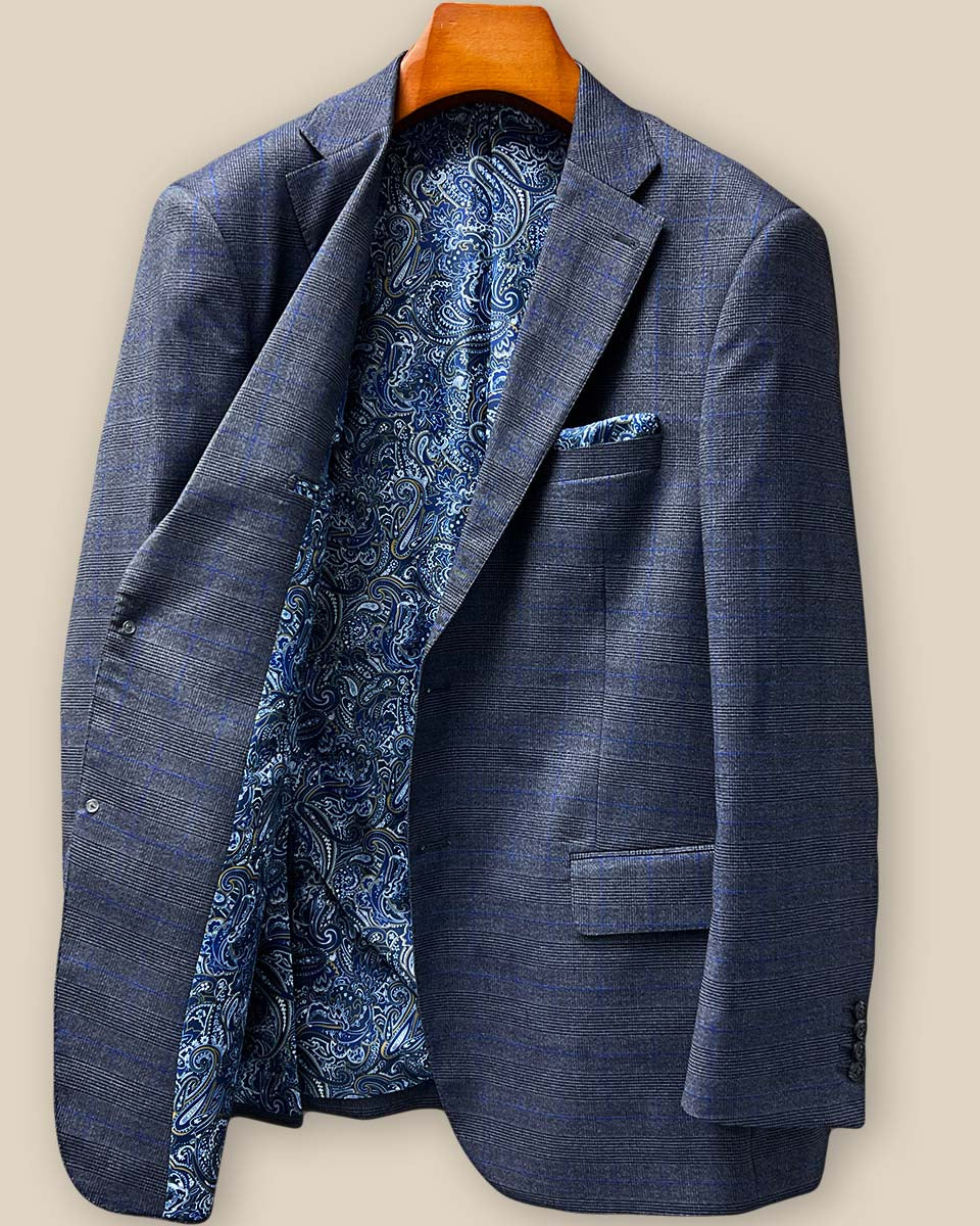 Interior right side view of the bespoke jacket showing additional inner pockets and the continuation of the blue paisley lining with gold and white details