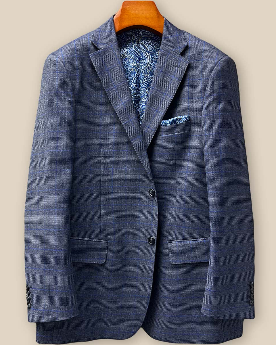 Close-up detail of the premium grey marble horn buttons fastened on the medium grey windowpane suit front, showing the natural variations in each button