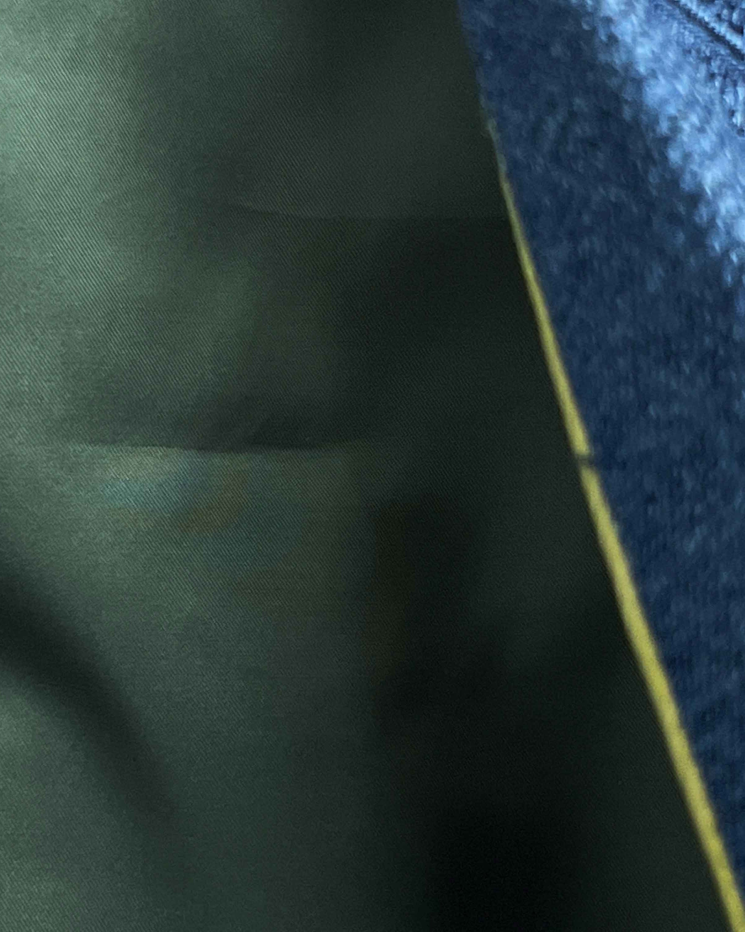 Olive green flash lining detail visible at jacket cuffs and vents in bemberg silk