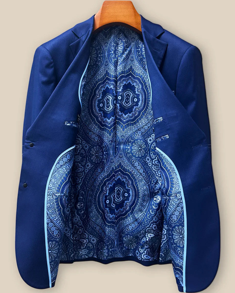Full interior view of custom suit jacket showcasing luxurious rich blue intricate paisley lining with Westwood Hart branding