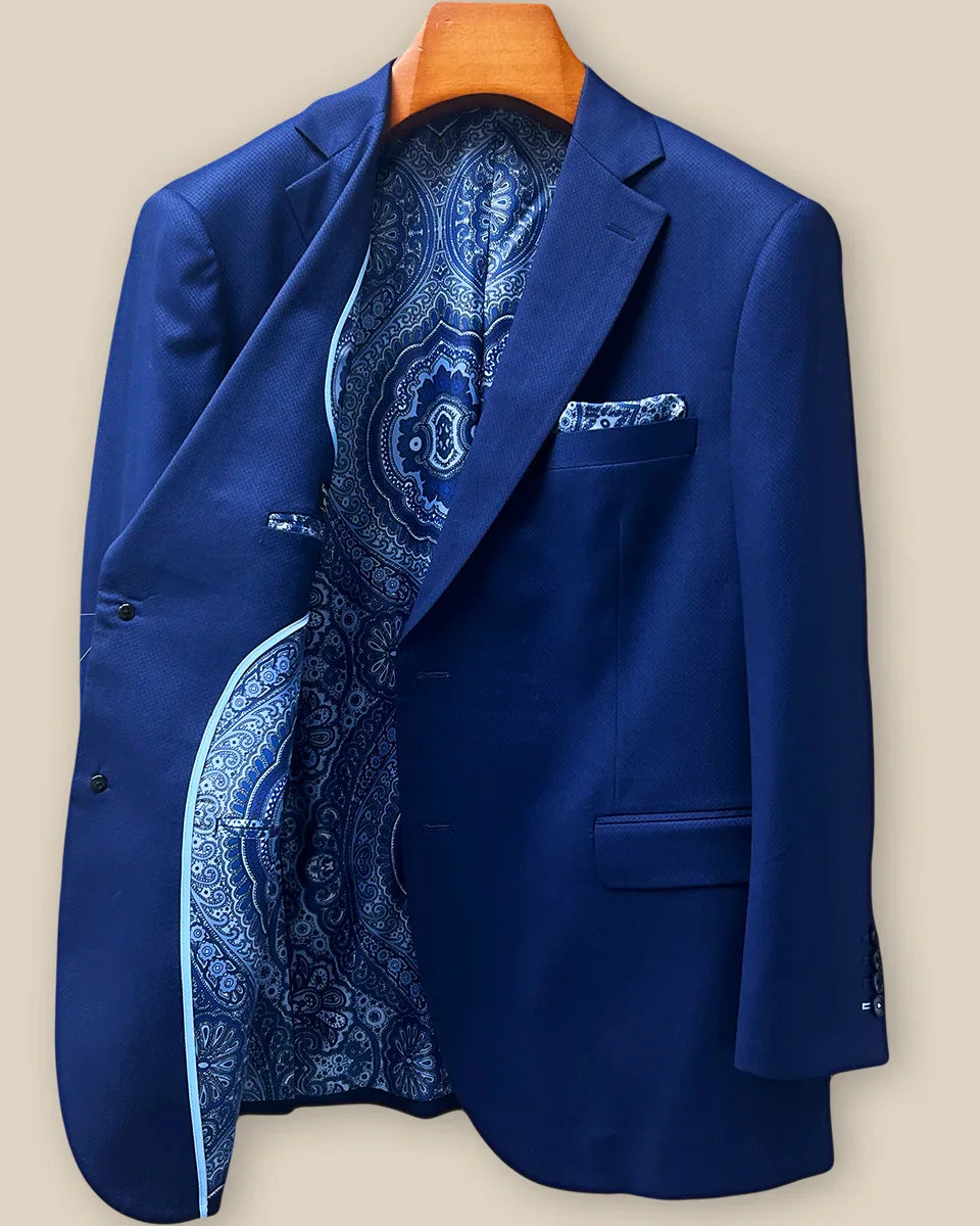 Interior right side of navy blue geometric textured suit jacket revealing paisley lining and internal construction details