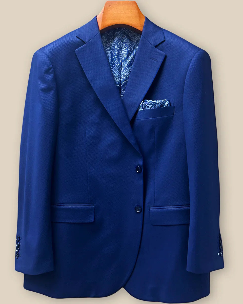 Front button panel of navy blue geometric textured suit jacket featuring navy blue horn buttons and hand pick stitching