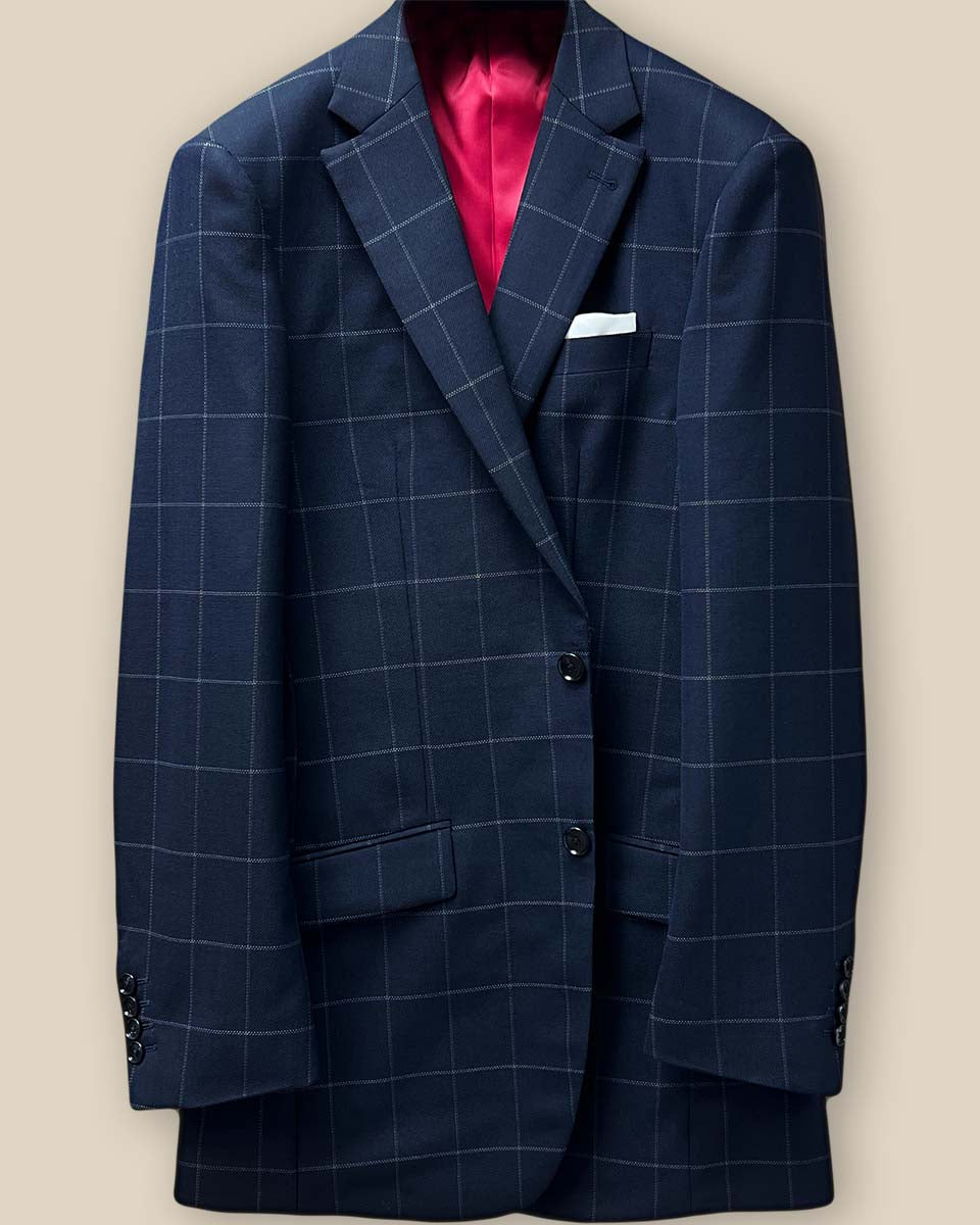 Close-up of navy horn buttons on front of navy windowpane suit jacket