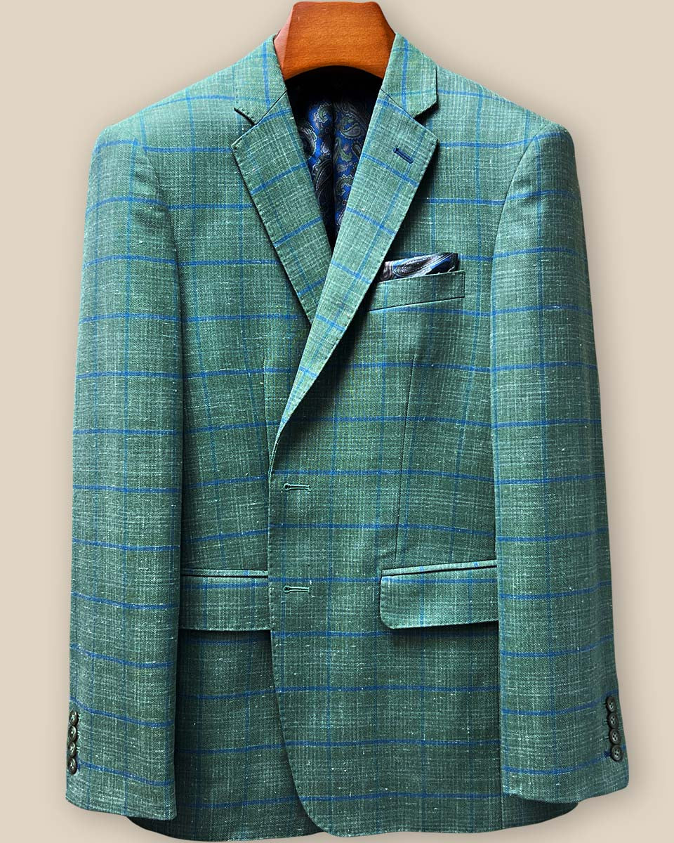 Detailed close-up of royal blue contrast buttonhole stitching on olive green windowpane sport coat lapel, showcasing precision hand-finished tailoring details