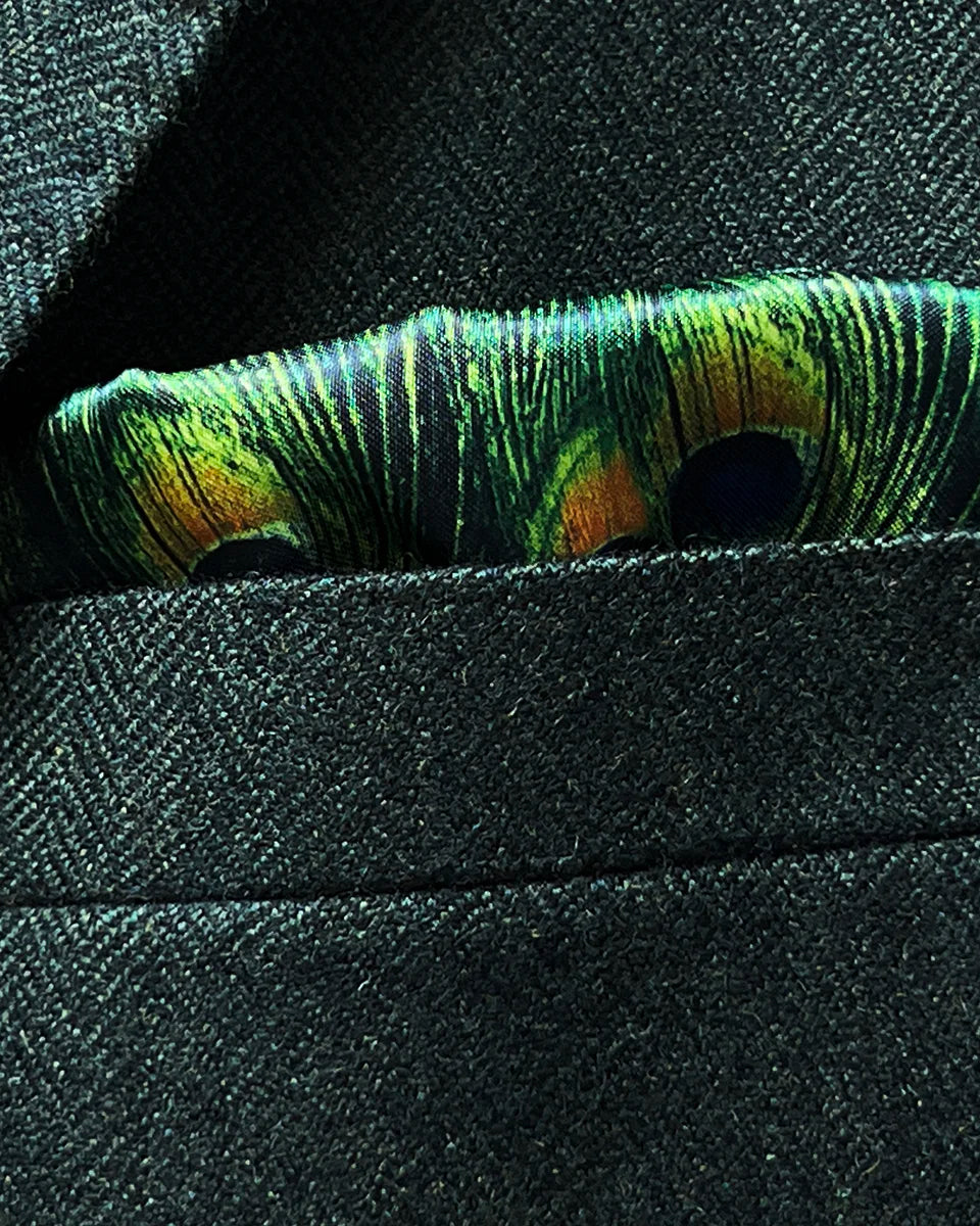 Built-in pocket square feature in matching olive herringbone tweed with complementary border detail