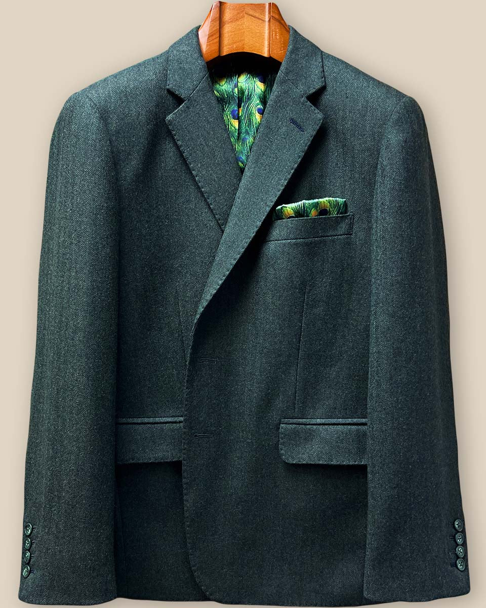 Elegant black contrast buttonhole detail on olive green herringbone tweed sport coat showing precise hand stitching and horn button closure