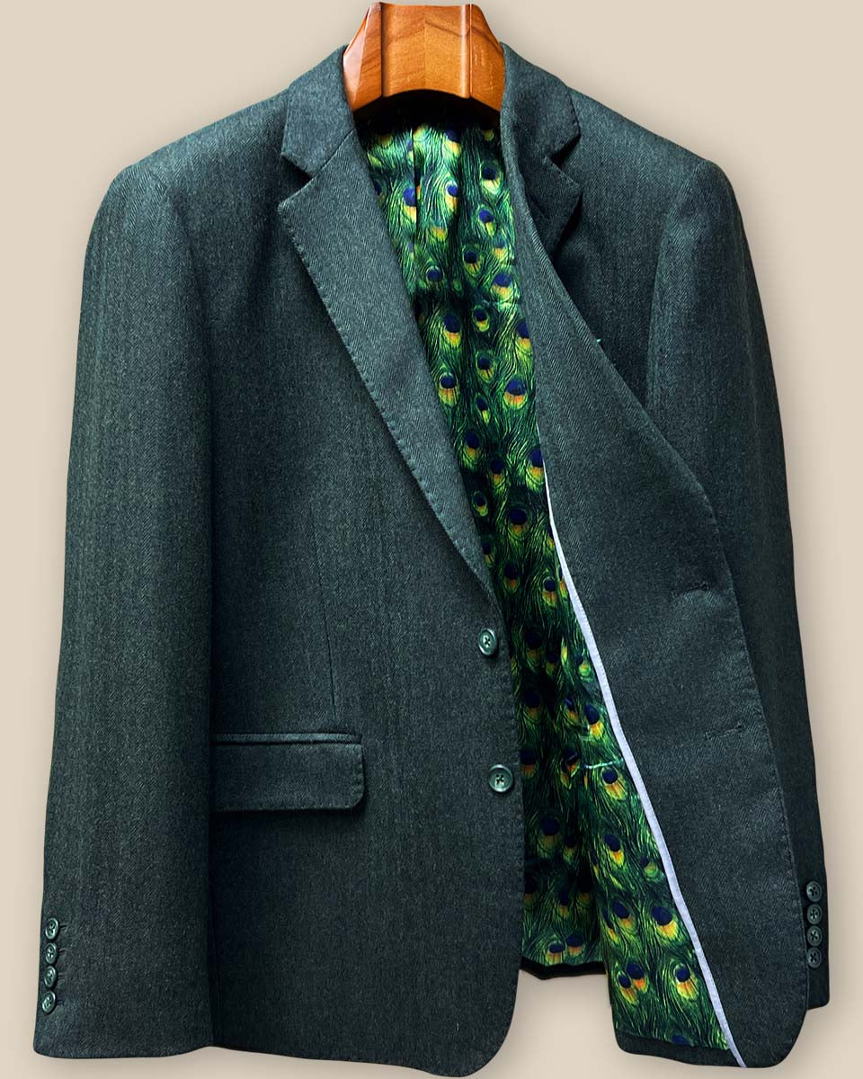 Interior left panel of olive tweed sport coat featuring luxurious green peacock feather pattern lining and inside breast pocket