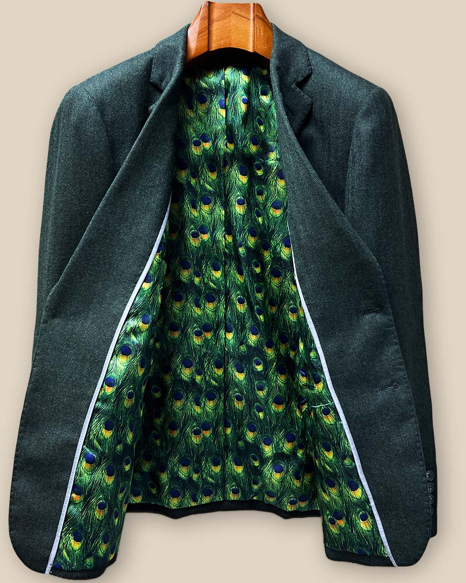 Full view of stunning green peacock feather fancy lining in custom olive herringbone tweed sport coat showing intricate pattern detail