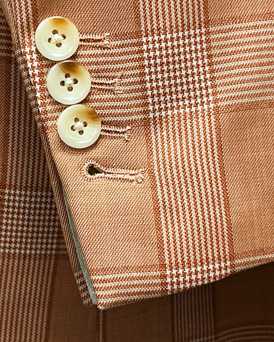 Detail shot of jacket sleeve showing slanting functional buttonholes with ivory marble horn buttons