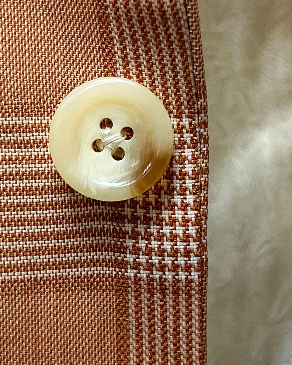 Detailed view of ivory marble horn buttons used on the suit jacket and vest