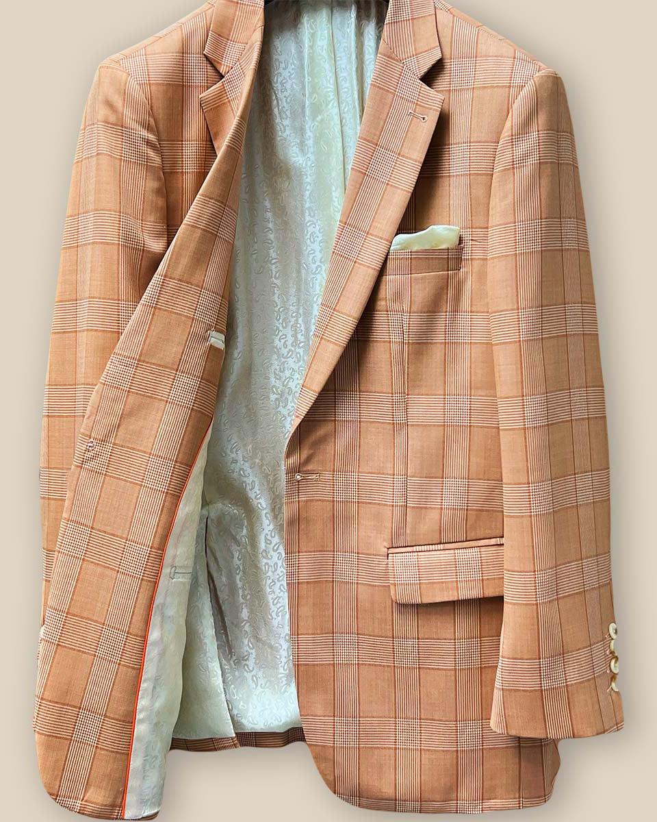 Interior view of orange suit jacket's right side, highlighting inner pocket details and lining