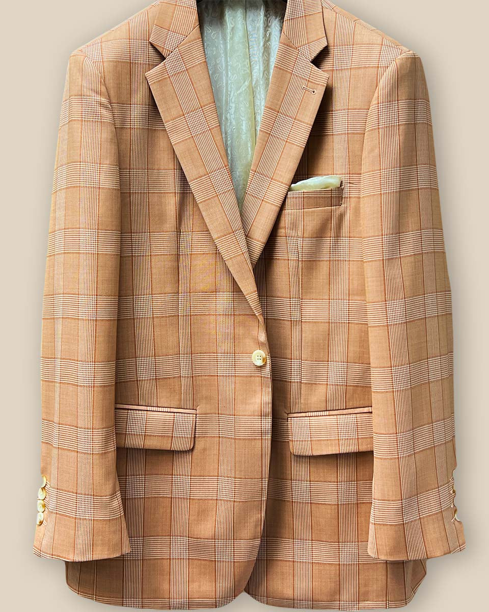 Close-up of suit jacket's front, focusing on single ivory marble horn button and buttonhole