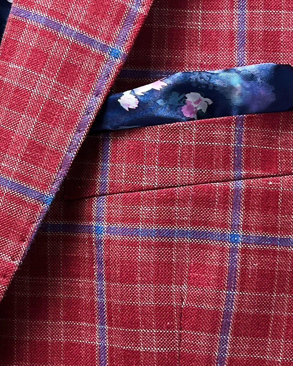 View of the sport coat's built-in pocket square, highlighting the contrast between the red windowpane fabric and the floral lining.