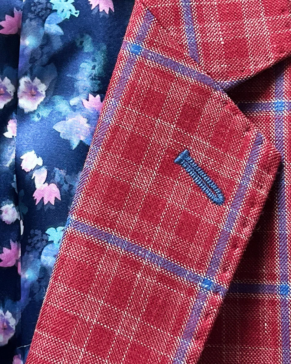 Close-up of the sport coat's notch lapel, showcasing the red with navy windowpane pattern and the navy accent buttonhole.