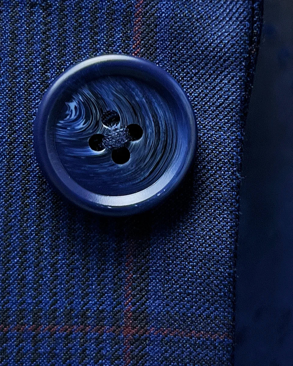 Artistic close-up of navy marble horn buttons displaying natural texture and sophisticated color coordination