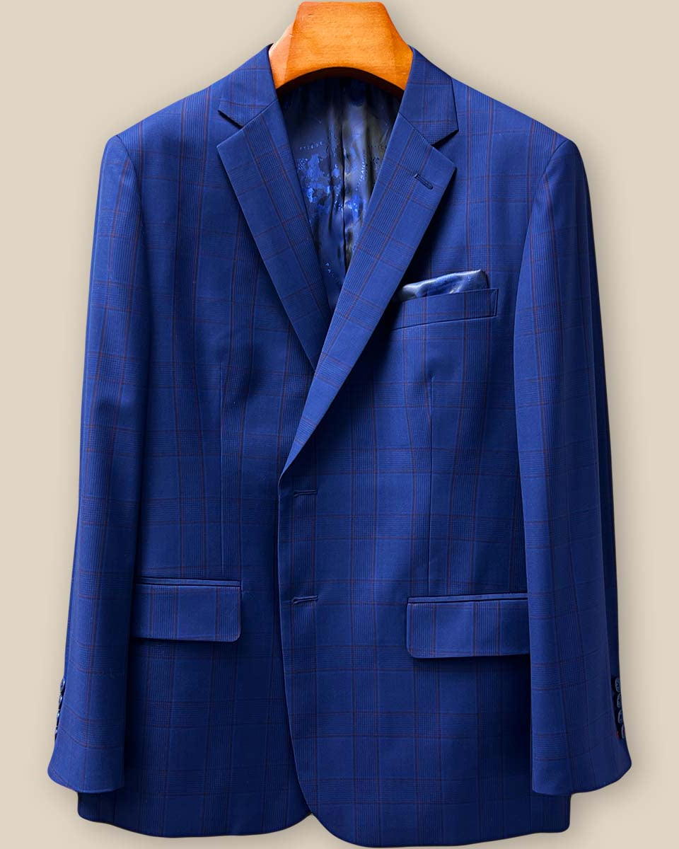 Close-up detail of royal blue Prince of Wales plaid suit jacket showing crimson red contrast buttonhole stitching on the lapel panel with navy marble horn buttons