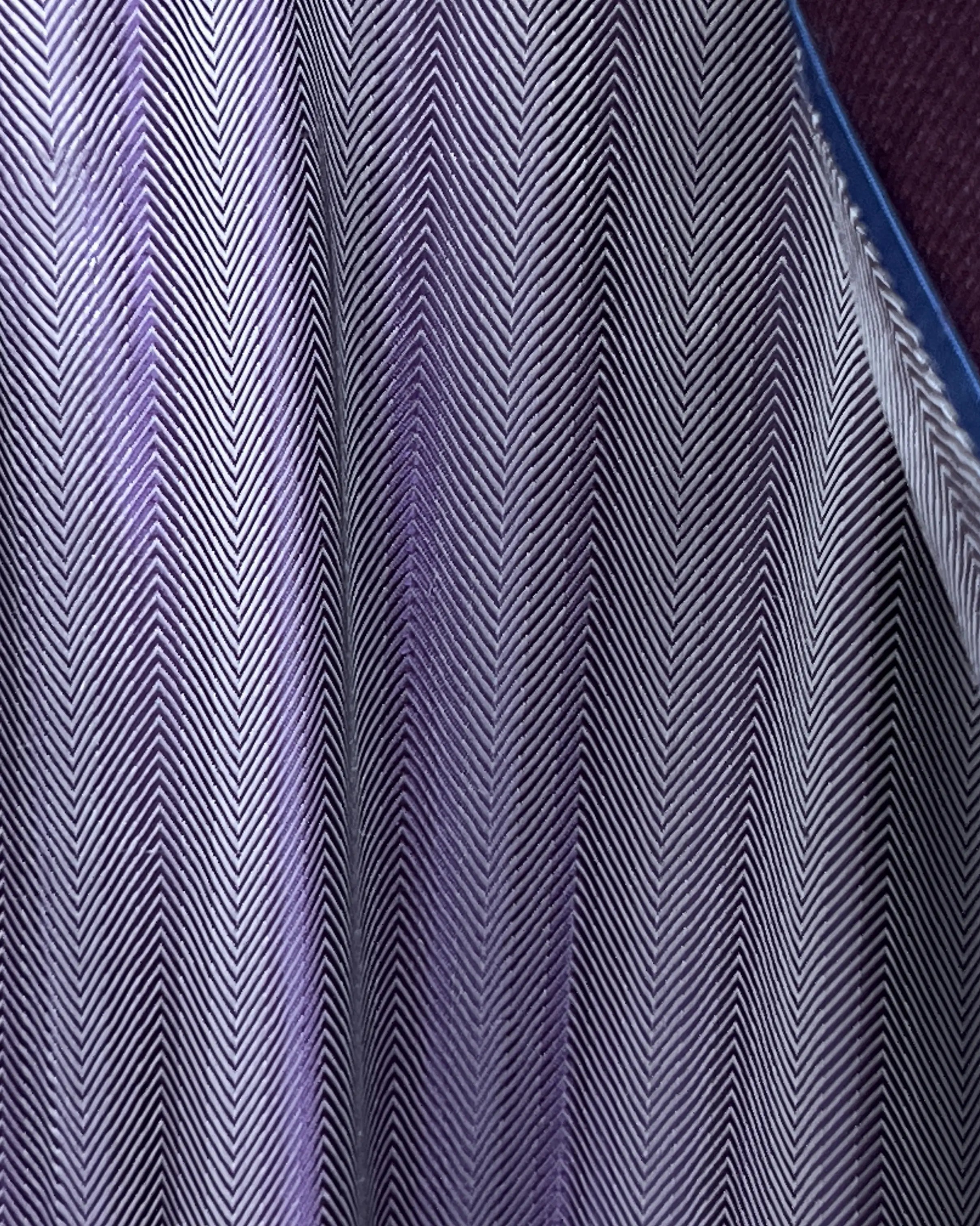 Lining detail of deep plum burgundy birdseye men's sport coat showing interior herringbone lining