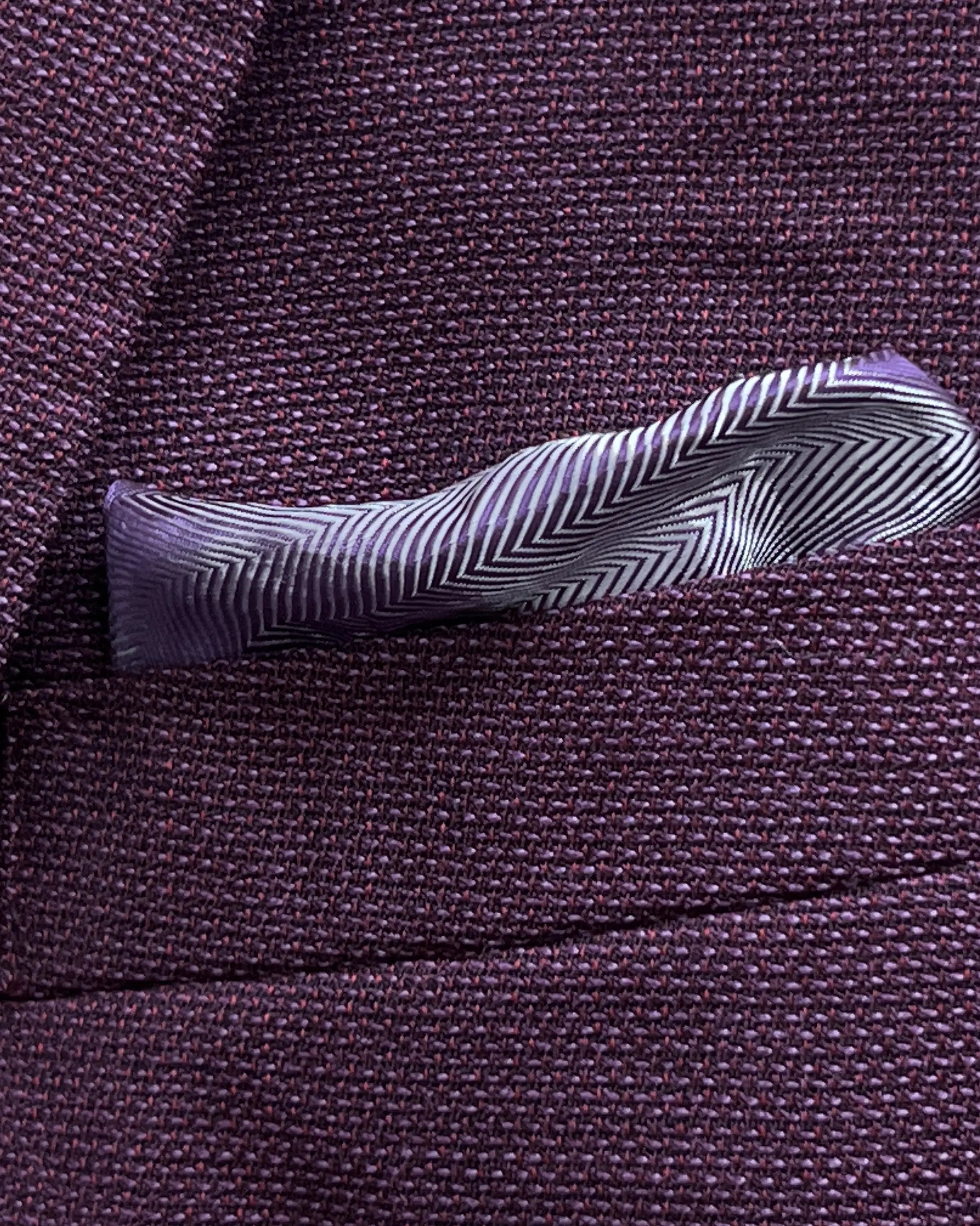 Pocket square detail of deep plum burgundy birdseye men's sport coat showing matching lining pocket square