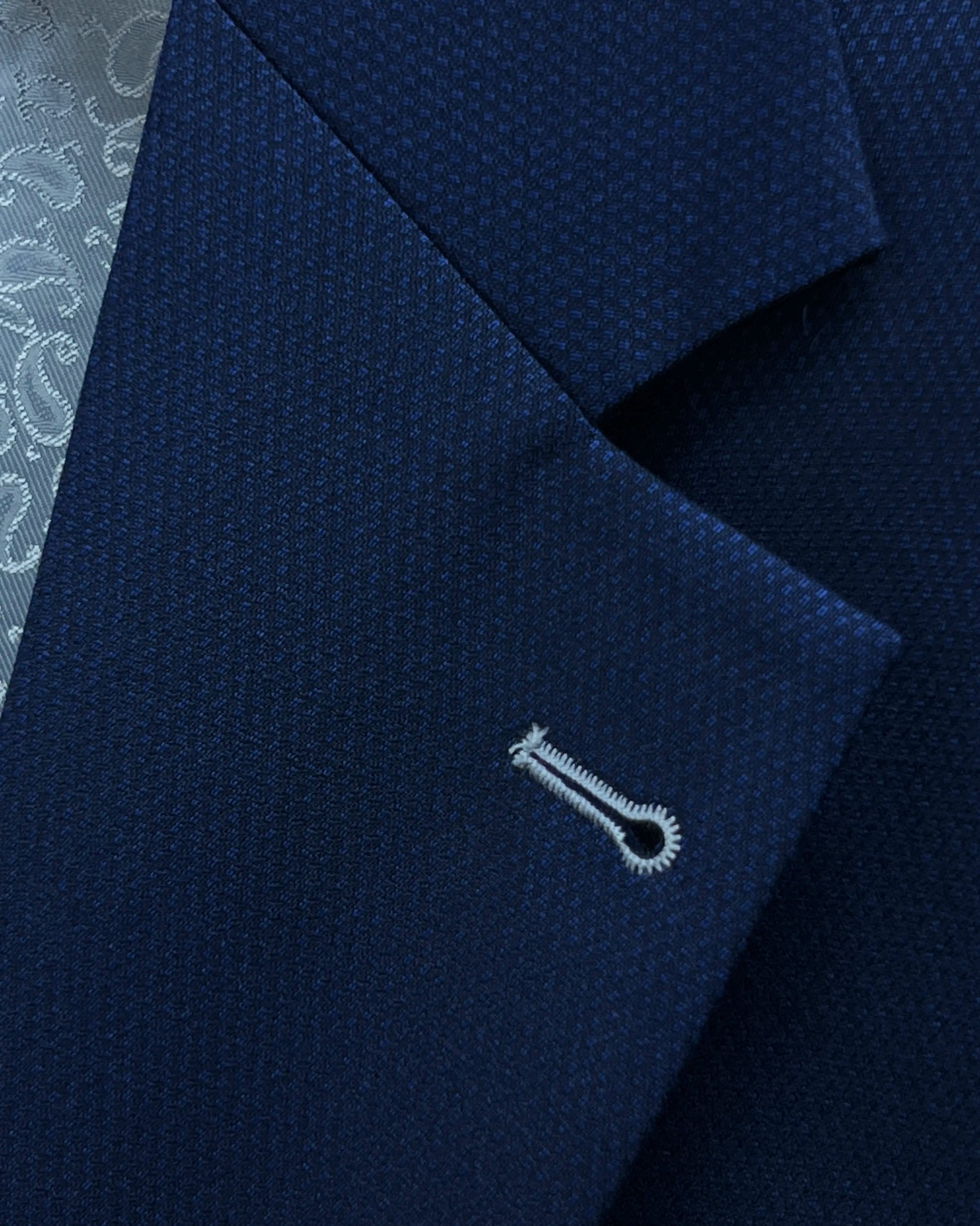 Lapel close up of Royal blue Birdseye men's sport coat showing the ivory contrast lapel buttonhole