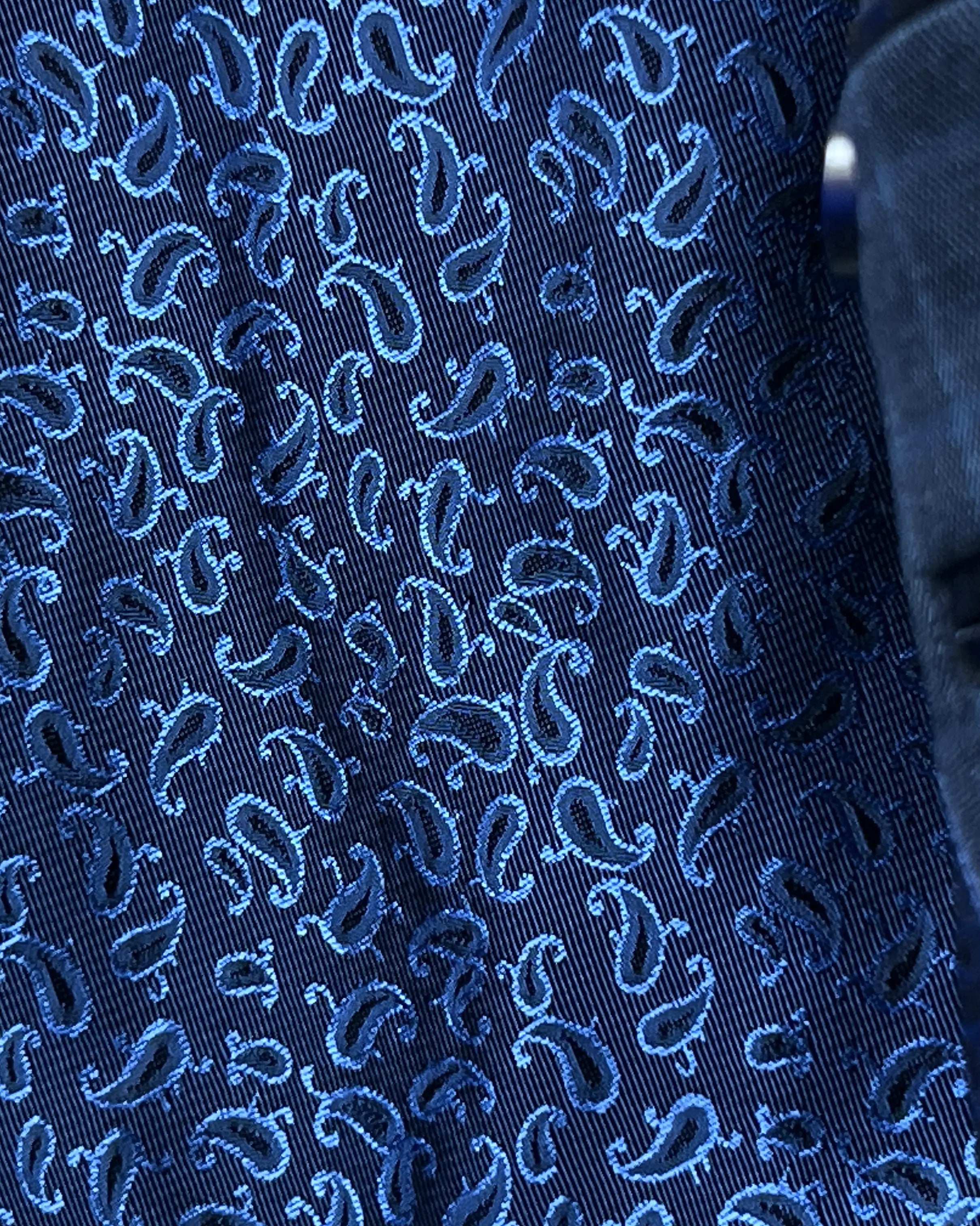 Lining close up of slate blue windowpane check men's sport coat showing blue patterned Bemberg silk lining