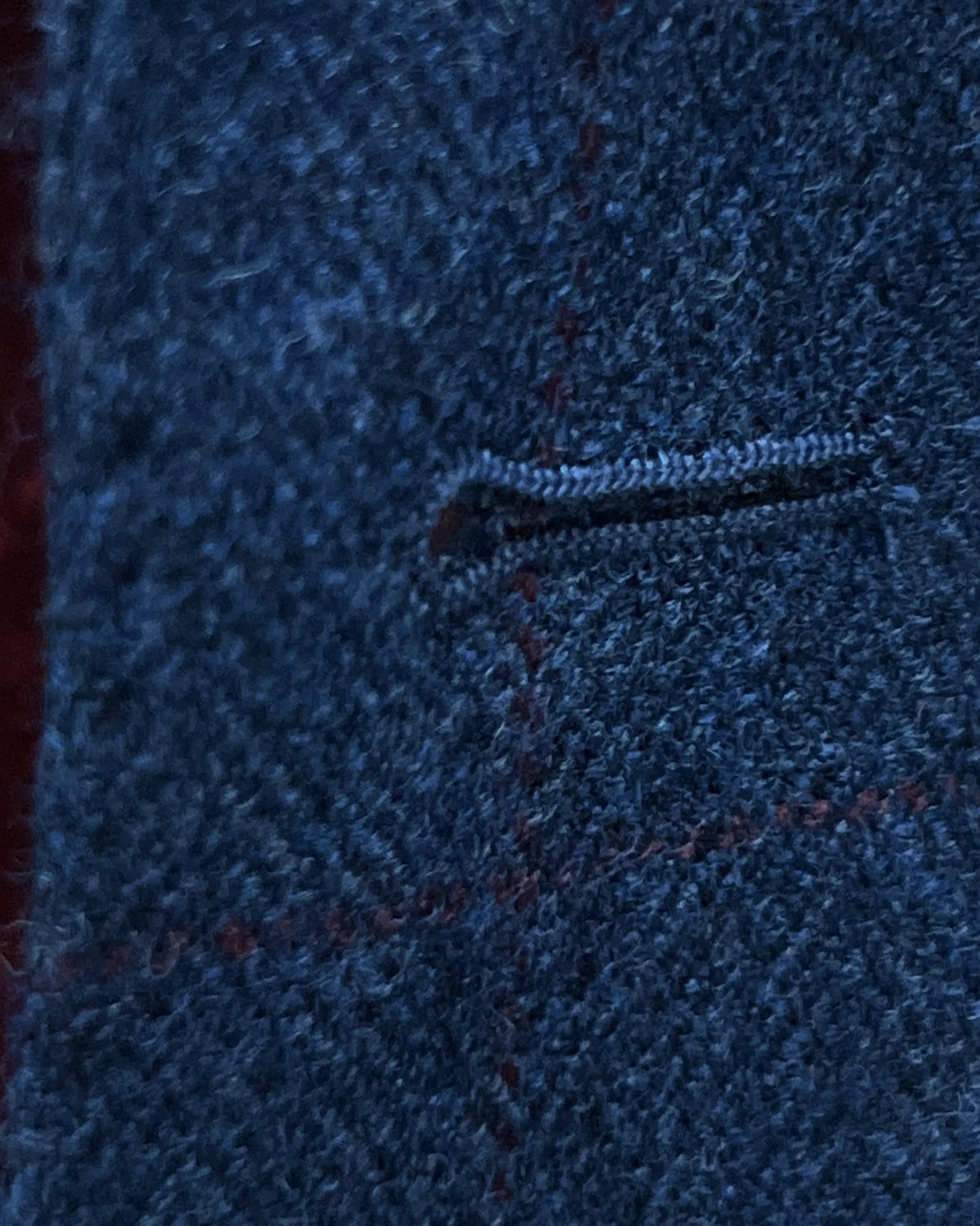 Buttonhole detail of teal blue with red windowpane men's sport coat showing the front buttonhole finish