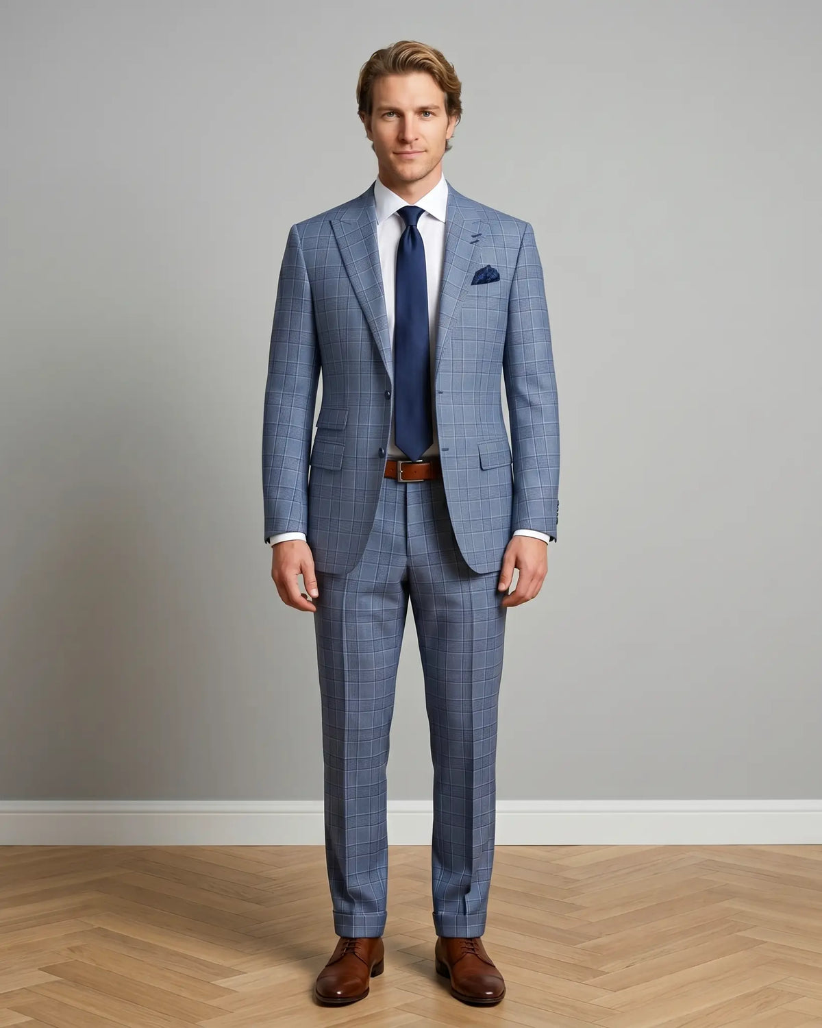 Front model view of light blue Prince of Wales glen plaid with navy windowpane men's suit showing full body styling
