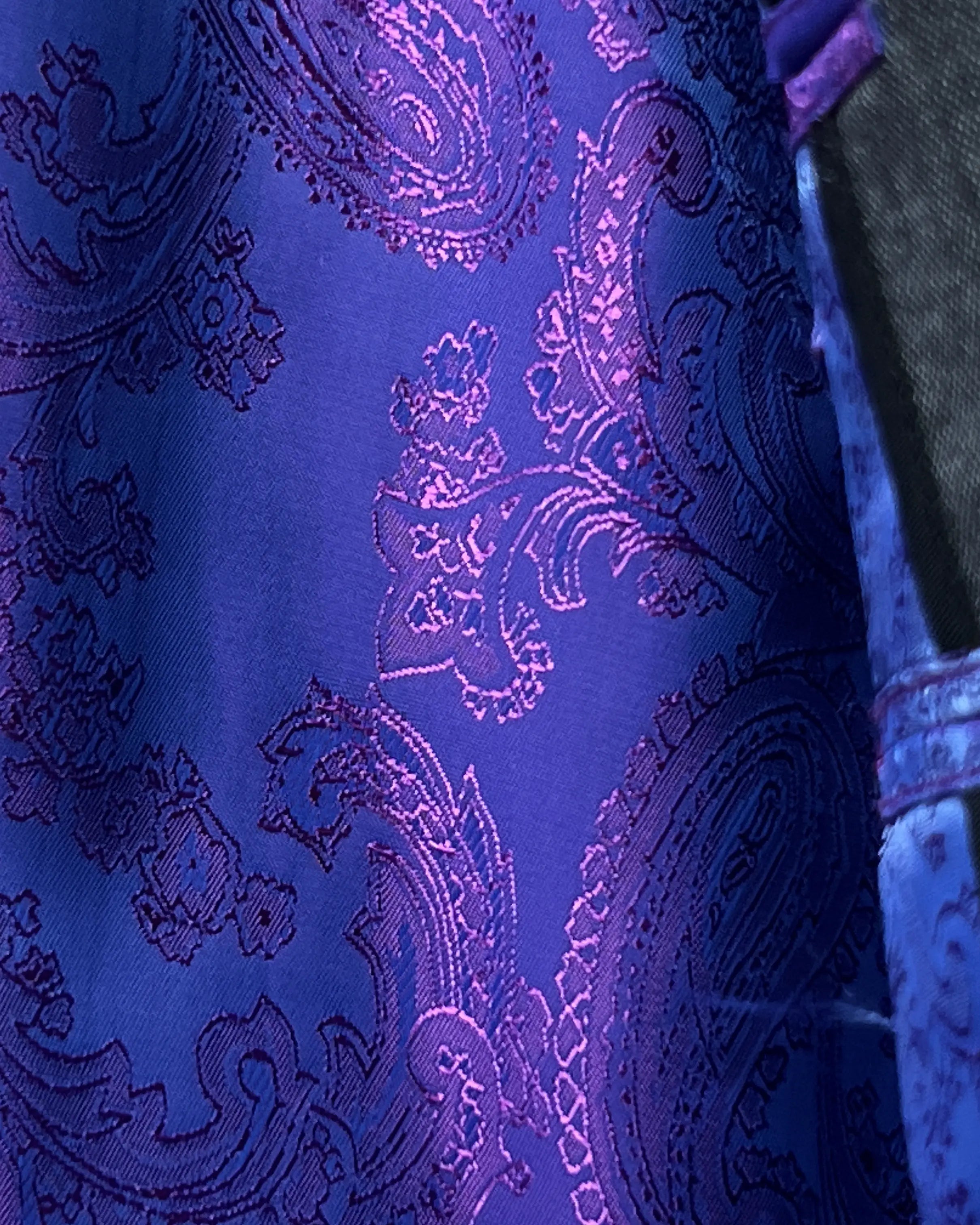 Bemberg silk lining close up of medium grey sharkskin men's suit showing purple paisley lining detail