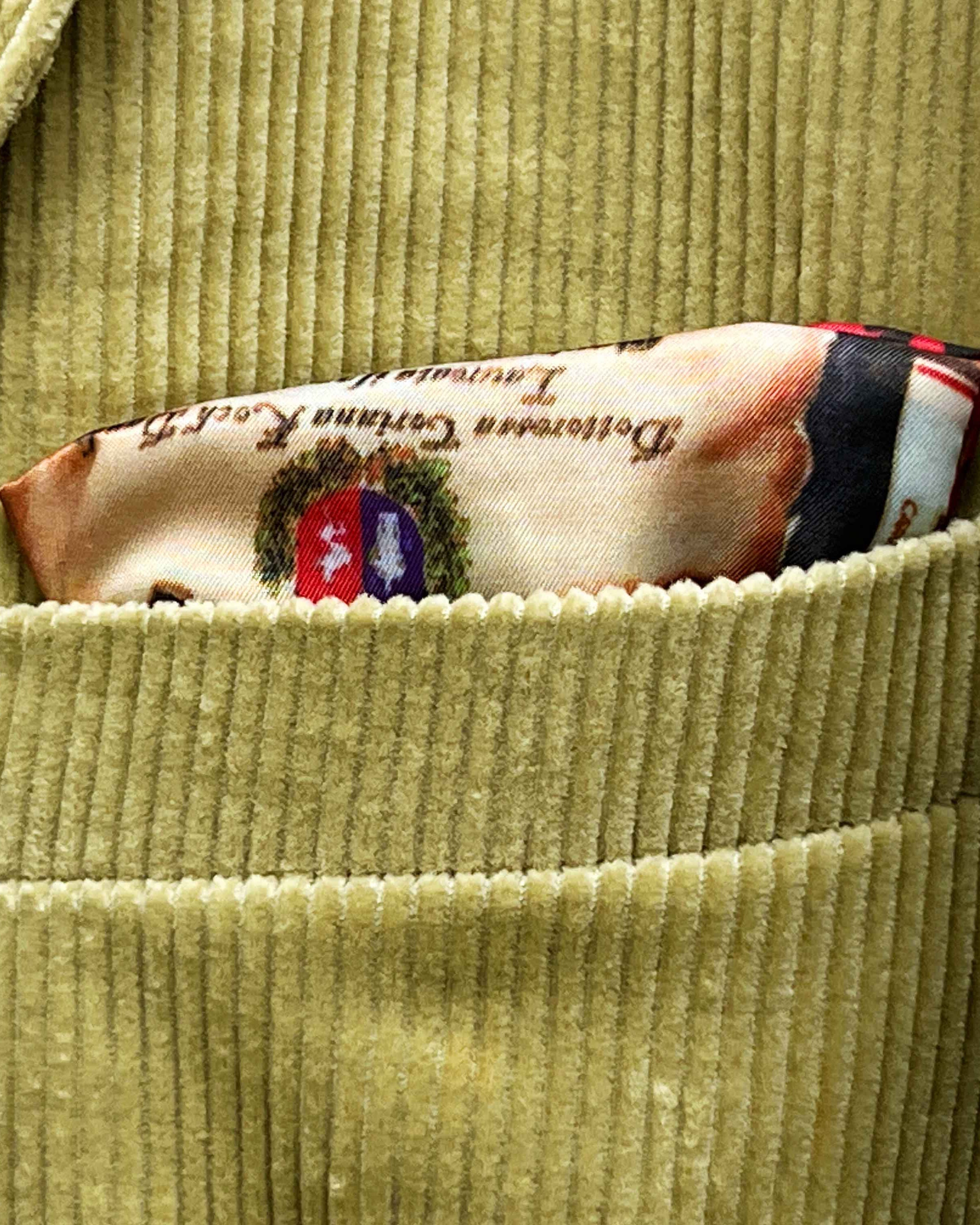 Breast pocket of tan corduroy sport coat with hand-finished edges and pick stitching detail