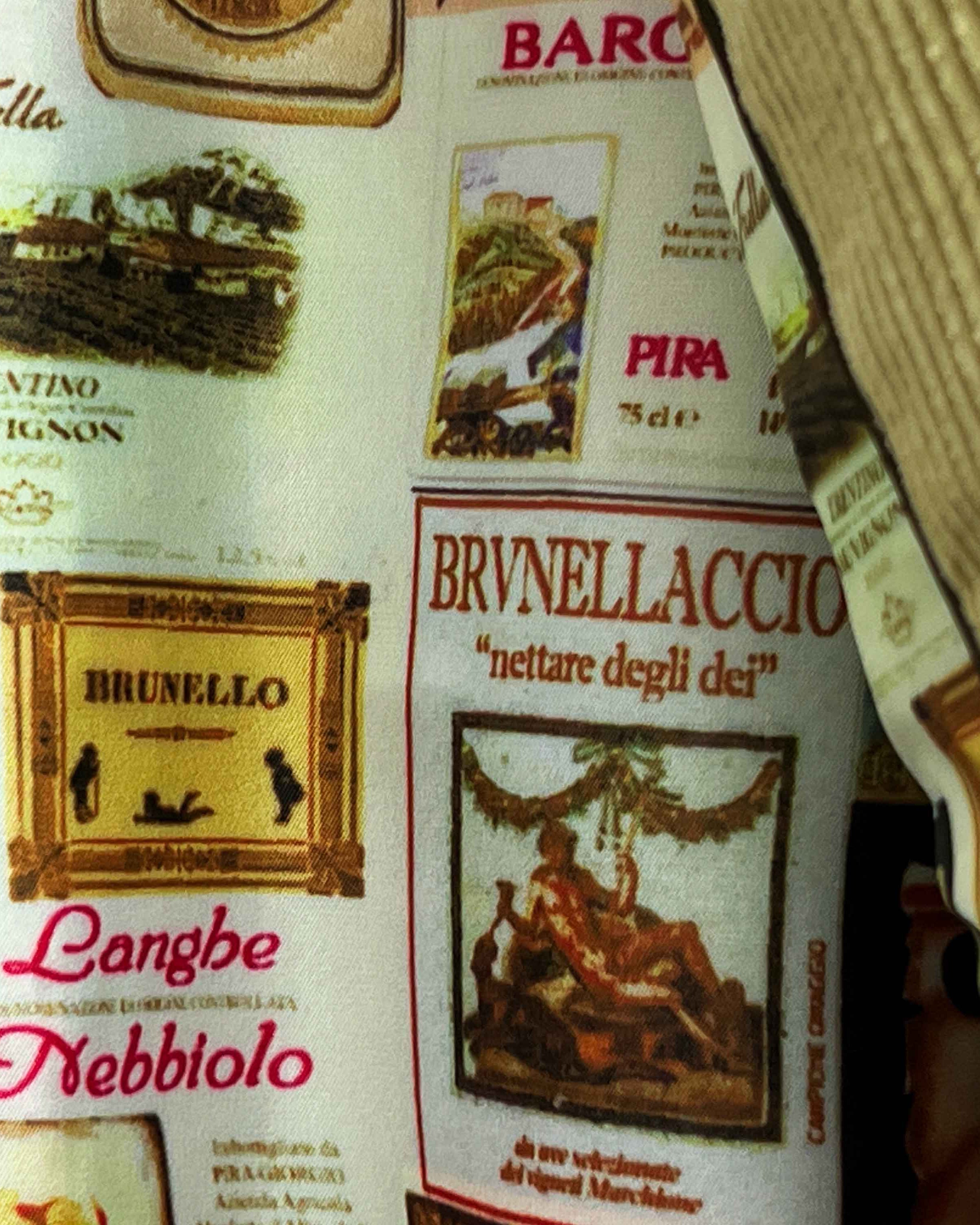 Colorful flash lining detail visible at jacket cuffs and vents in wine labels and wine bottles print pattern