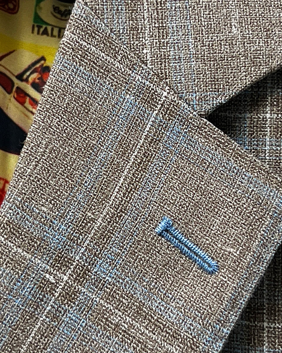 Classic notch lapel detail on tan blue windowpane sport coat showing hand pick stitching and blue check pattern