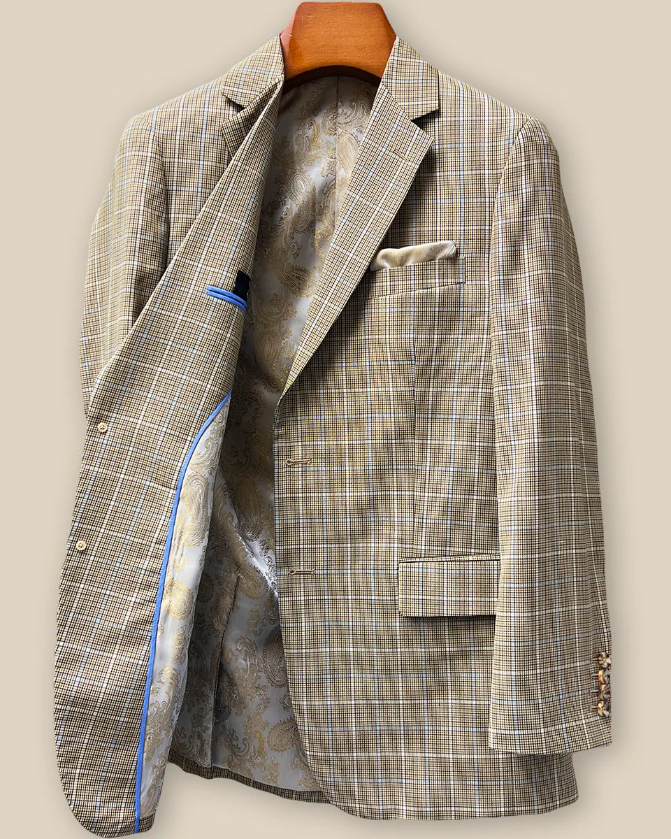 Interior right side of tan brown sport coat revealing champagne gold paisley lining and internal construction details