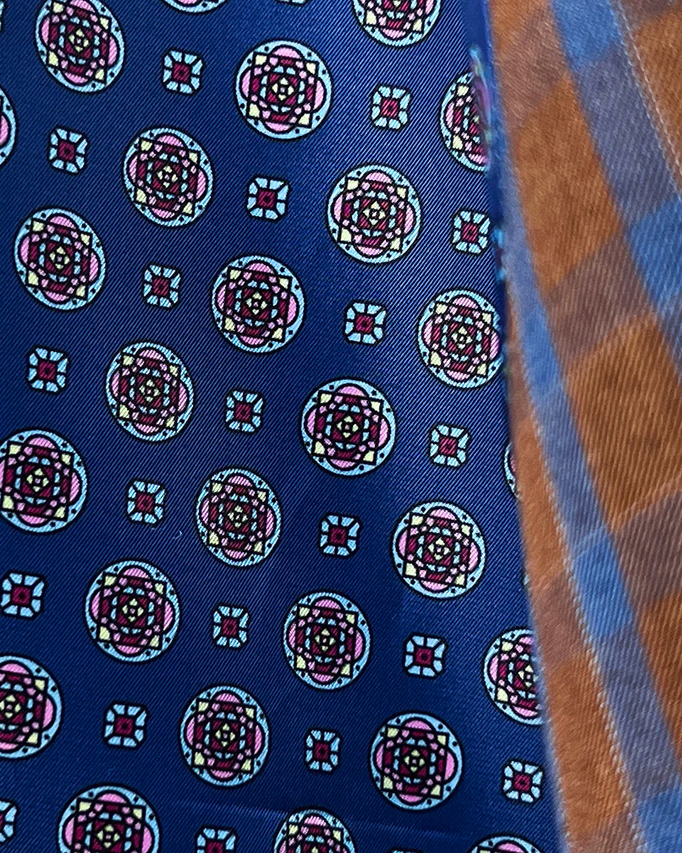 Interior flash lining detail highlighting dark blue geometric circular medallions pattern and premium lining construction quality