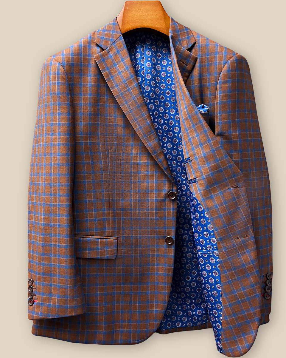 Interior left side view displaying dark blue geometric circular medallions flash lining with inner chest pocket and quality construction details