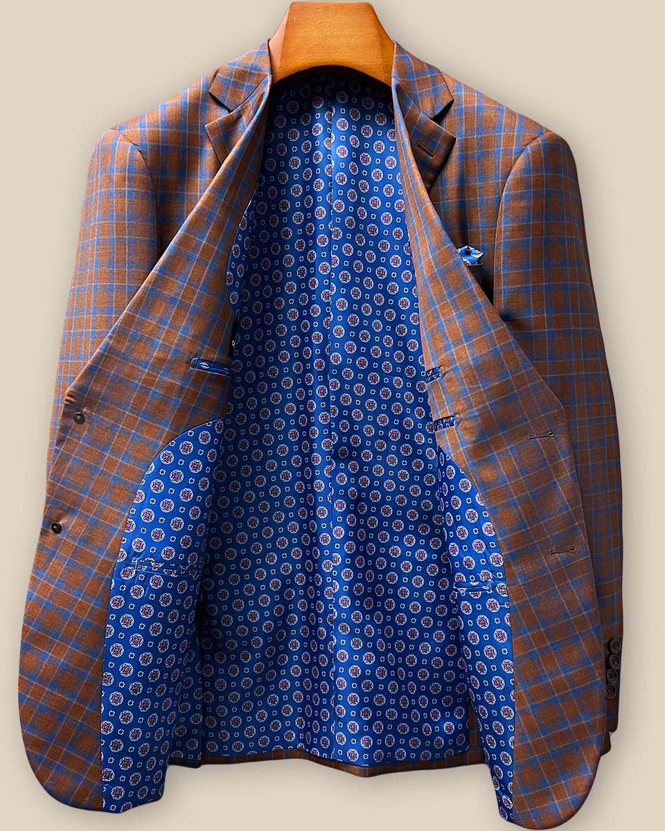 Full interior lining showcase featuring dark blue geometric circular medallions pattern with brand label and superior tailoring craftsmanship