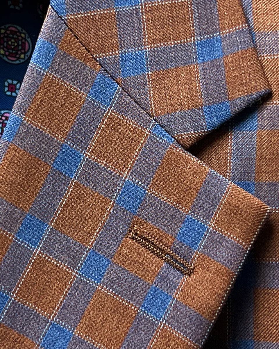 Classic notch lapel detail showcasing clean lines, proper proportions, and tobacco brown cobalt blue check pattern at lapel edge