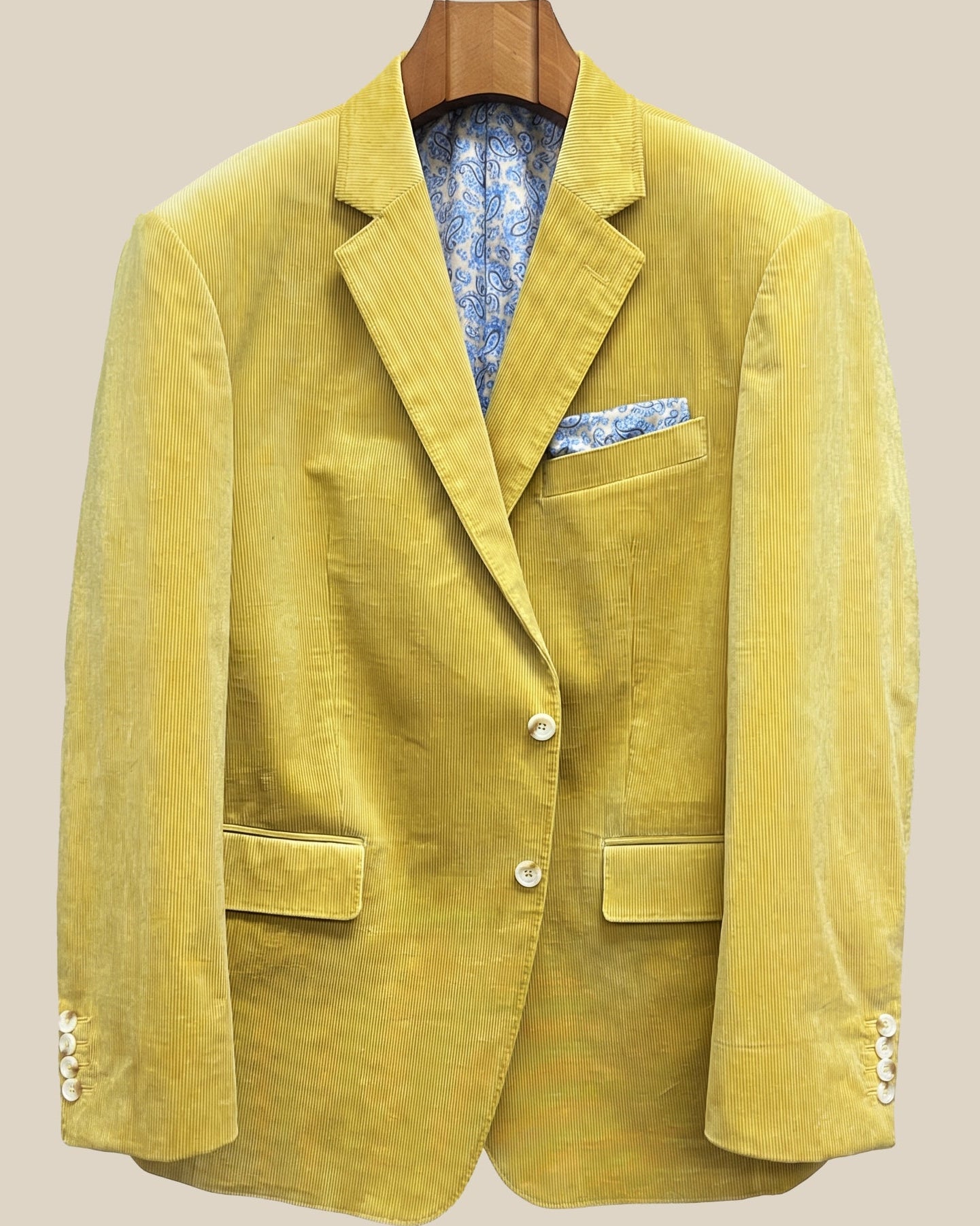 Front button panel of warm mustard yellow corduroy sport coat featuring light cream horn buttons with caramel swirl and hand pick stitching