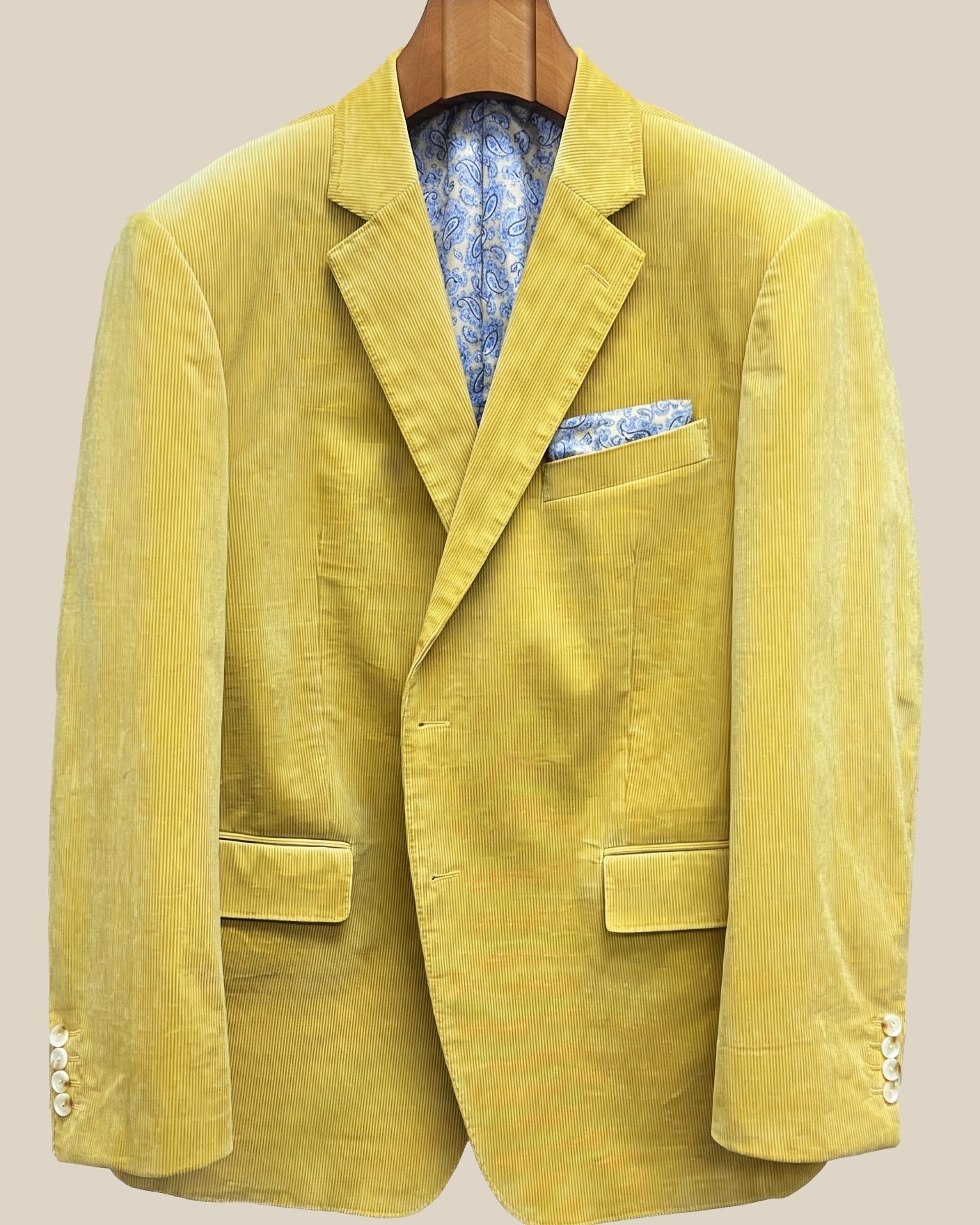 Close-up view of warm mustard yellow corduroy sport coat showing light cream horn buttons with caramel swirl and hand-finished pick stitching detail