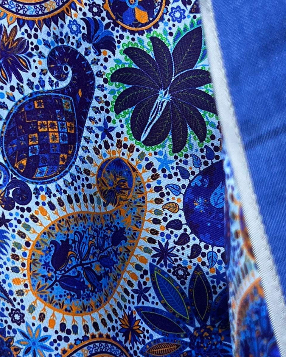 Colorful flash lining detail visible at jacket cuffs and vents in light blue, navy and gold paisley pattern