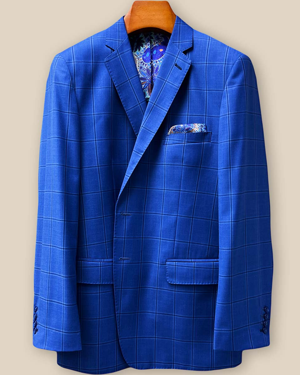 Close-up view of royal blue windowpane suit jacket showing contrast dark blue accent buttonhole with hand-finished stitching detail