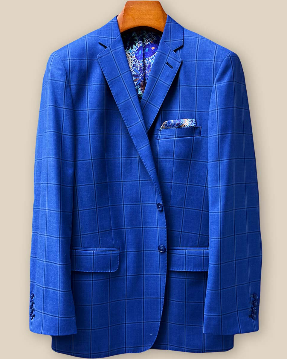 Front button panel of royal blue windowpane suit jacket featuring medium blue horn buttons and hand pick stitching