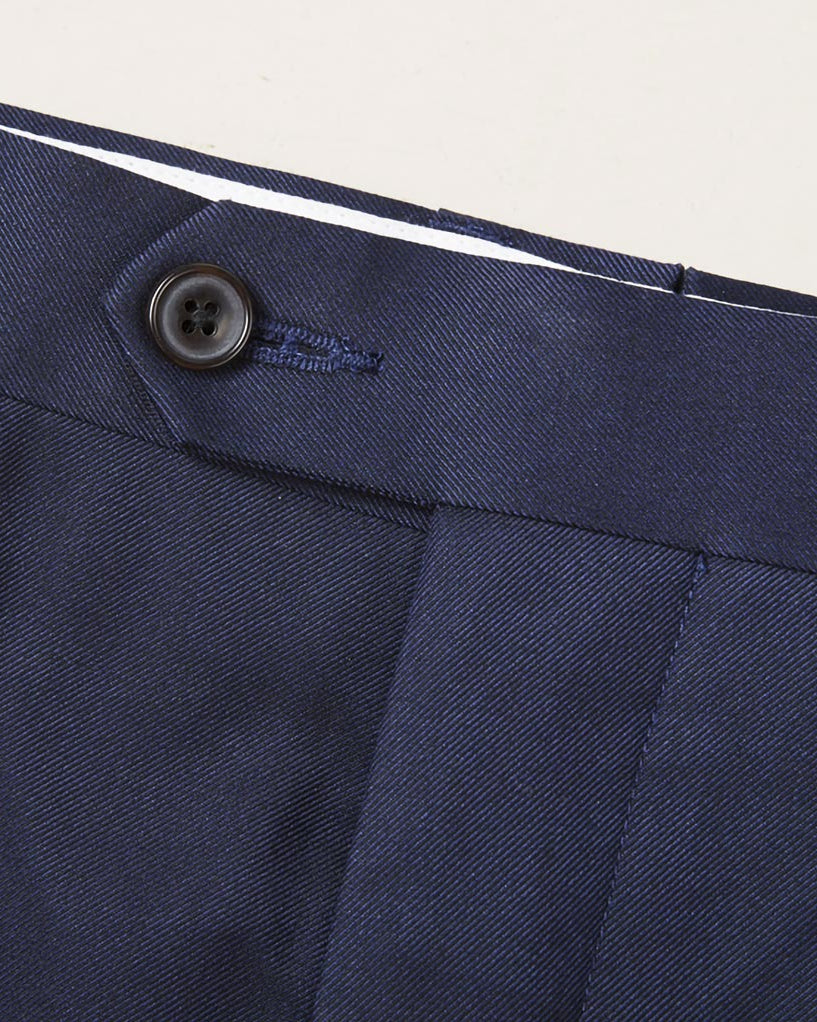 Custom tailored navy suit for work, showcasing the plain weave fabric and waistband of trousers
