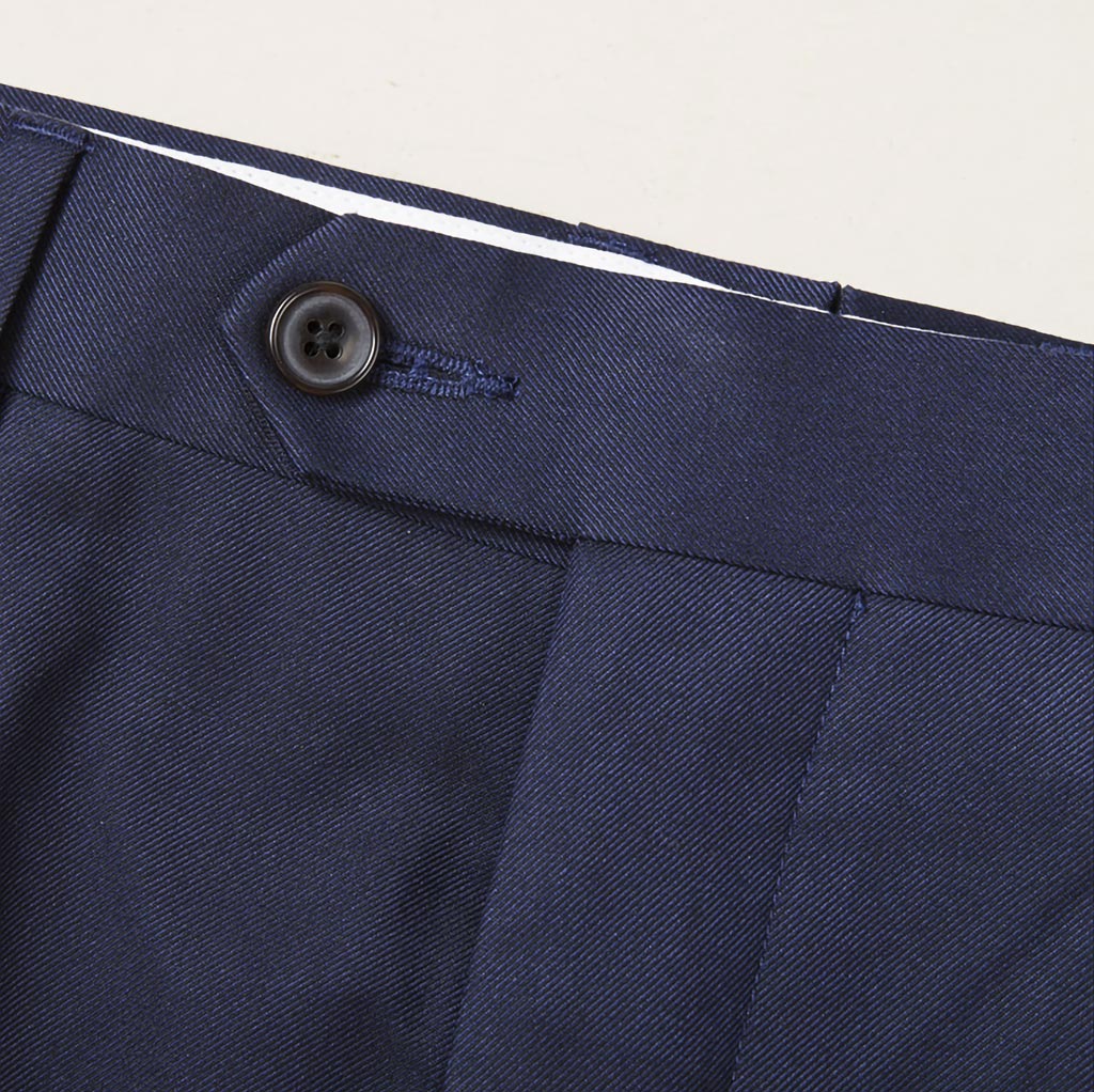 Custom tailored navy suit for work, showcasing the plain weave fabric and waistband of trousers