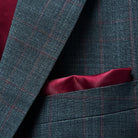 Cuff details on a grey and red windowpane suit, showcasing the fine Merino wool and meticulous tailoring.