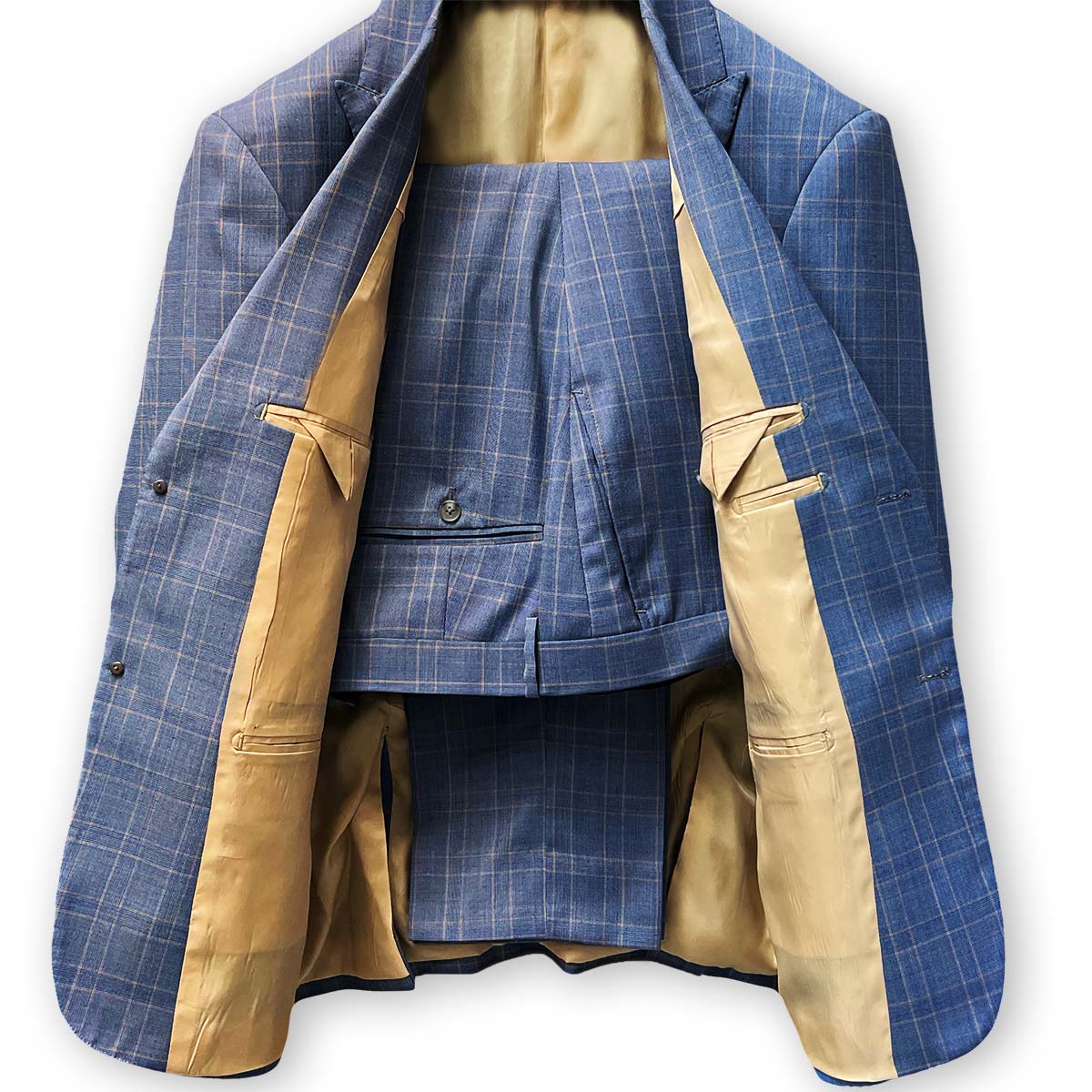 Horn buttons adding a luxurious touch to a stone blue suit.