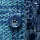 Detailed view of the turquoise marble horn buttons on the men's sportcoat.