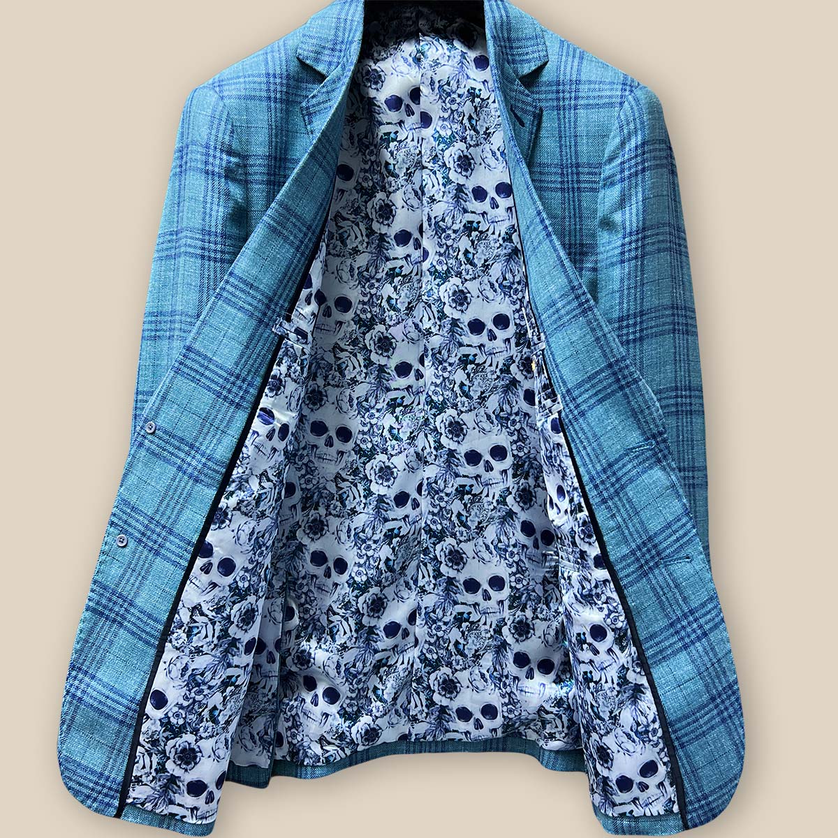 Full view of the men's sportcoat's interior, highlighting the intricate blue and white rose and skull fancy lining.