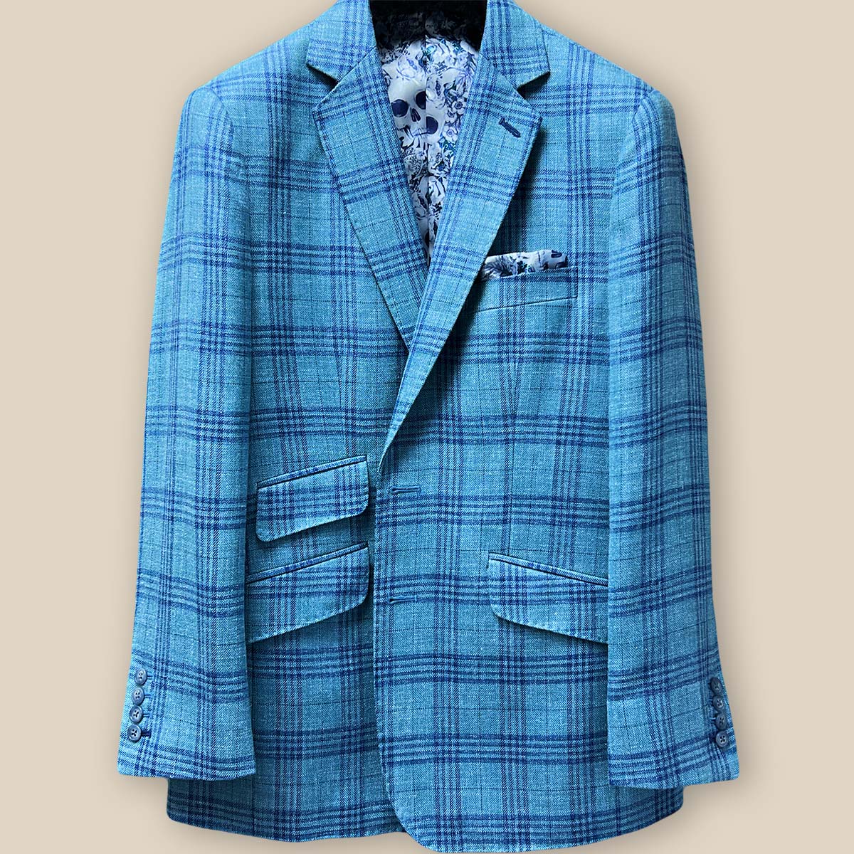 Close-up of the green with blue plaid men's sportcoat's buttonhole panel, featuring dark blue accent stitching.
