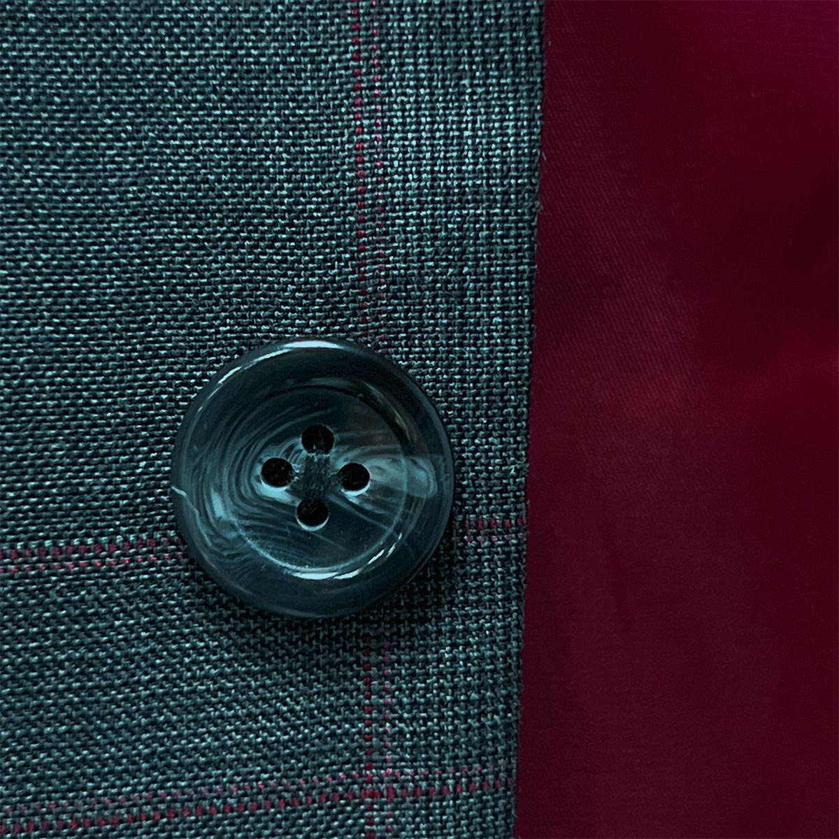 A man in motion wearing a grey windowpane suit, capturing its comfort and versatility.