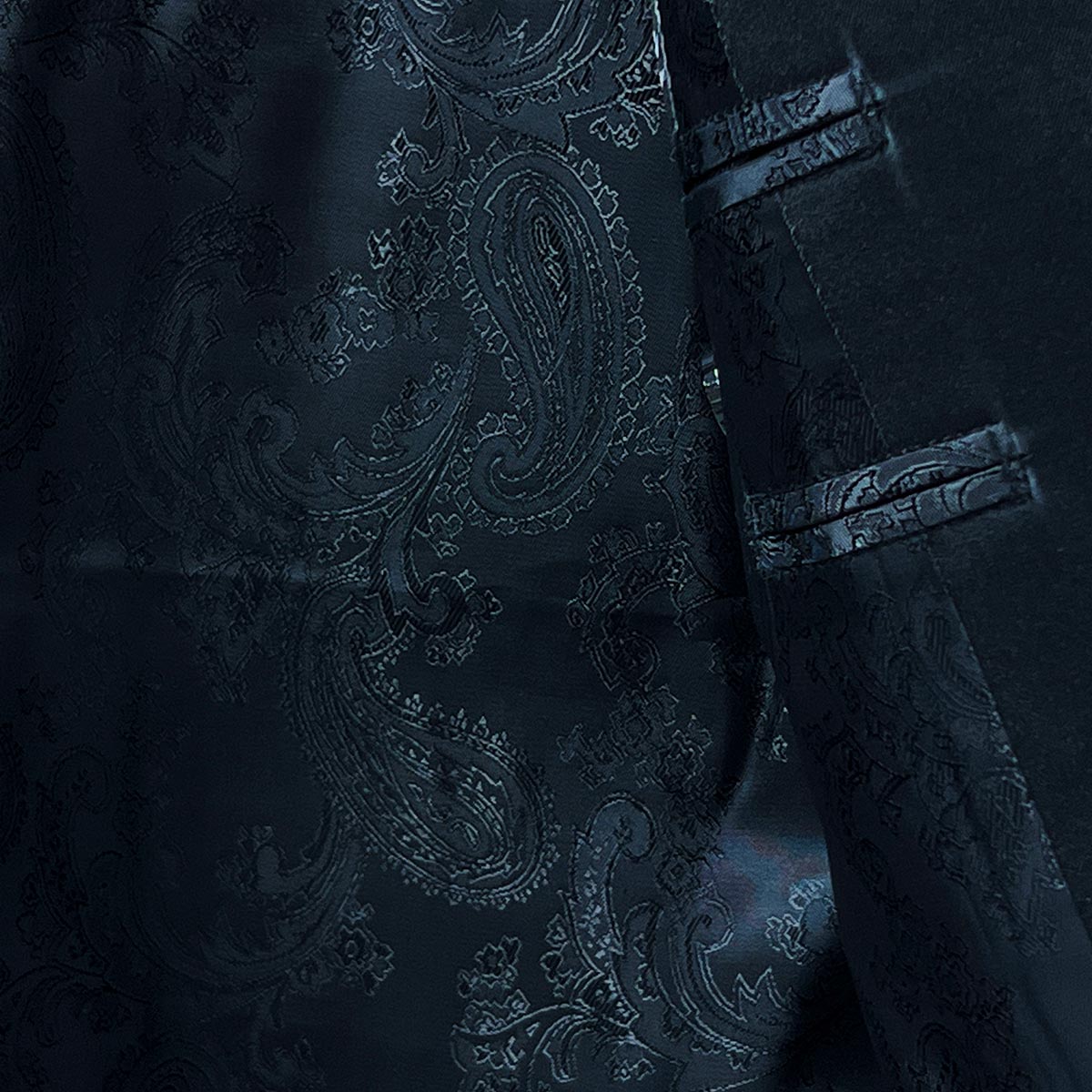 Inner lining of a velvet dinner jacket blue tuxedo, showcasing a rich texture and meticulous craftsmanship for formal attire.